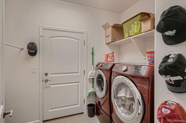 clothes washing area with washer and clothes dryer