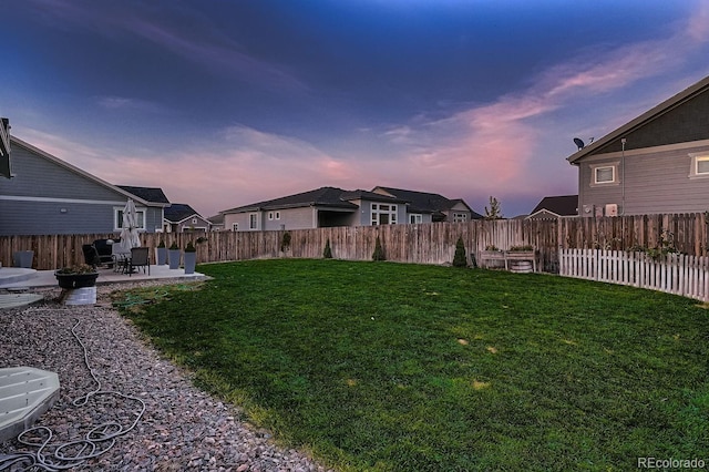 yard at dusk featuring a patio