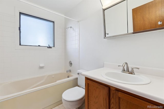 full bathroom with tiled shower / bath, vanity, and toilet