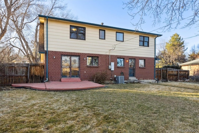 rear view of house with a yard, central AC unit, and a patio