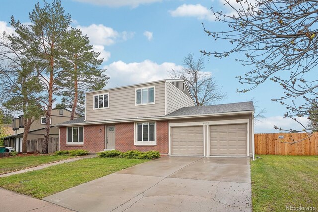 4623 S Kalispell Way, Aurora, CO 80015 - view of front facade with an attached garage, concrete driveway, and brick siding