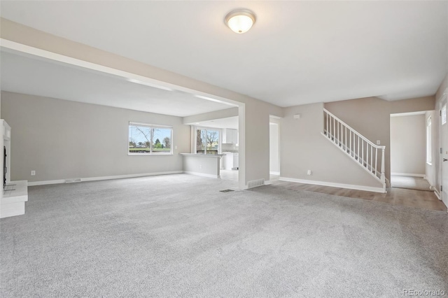 4623 S Kalispell Way, Aurora, CO 80015 - unfurnished living room with carpet, stairway, and baseboards