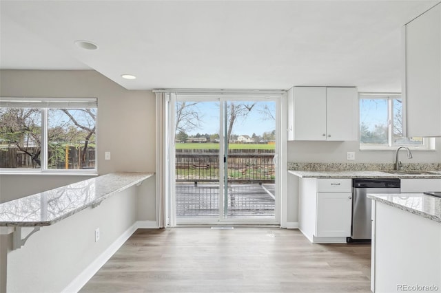 4623 S Kalispell Way, Aurora, CO 80015 - kitchen with dishwasher, a sink, white cabinetry, healthy amount of natural light, and recessed lighting