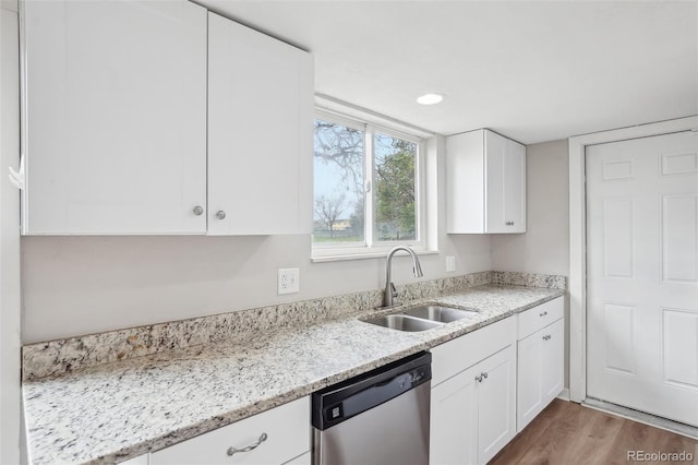 4623 S Kalispell Way, Aurora, CO 80015 - kitchen with stainless steel dishwasher, a sink, white cabinetry, wood finished floors, and recessed lighting