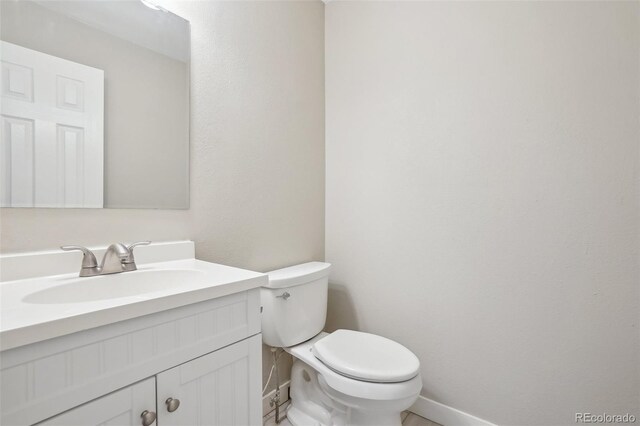 4623 S Kalispell Way, Aurora, CO 80015 - half bathroom with baseboards, toilet, and vanity