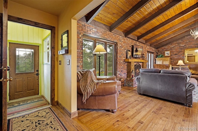 89 Aspen Leaf Ln, Bellvue, CO 80512 - living area featuring brick wall, light wood finished floors, wood ceiling, and a brick fireplace