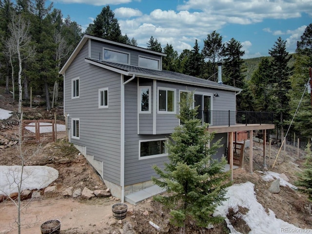 view of side of home with a wooden deck
