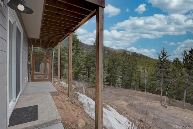 view of patio featuring a mountain view and a view of trees