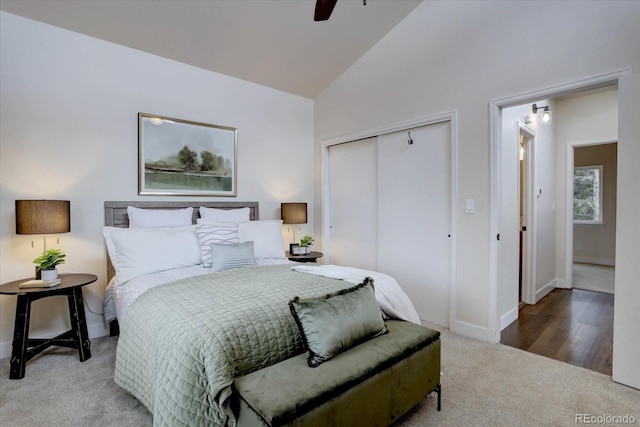 bedroom with a ceiling fan, high vaulted ceiling, a closet, carpet floors, and baseboards