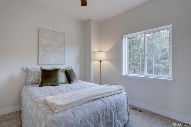 carpeted bedroom with baseboards and visible vents