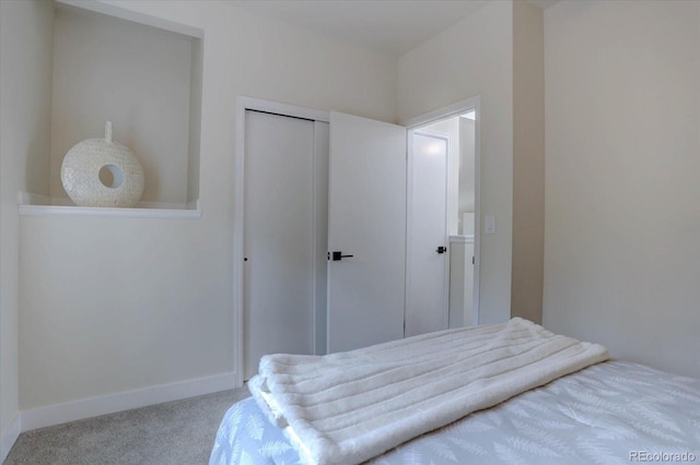 bedroom featuring carpet flooring, a closet, and baseboards