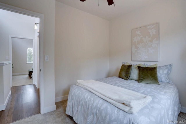 bedroom with baseboards, ceiling fan, and carpet