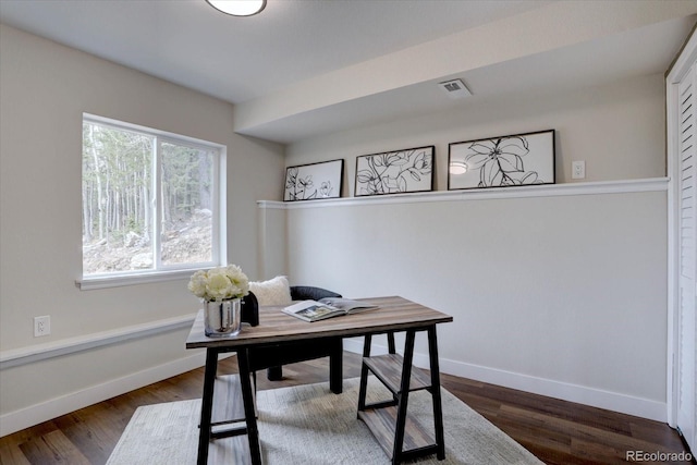office space with baseboards, dark wood-style floors, and visible vents
