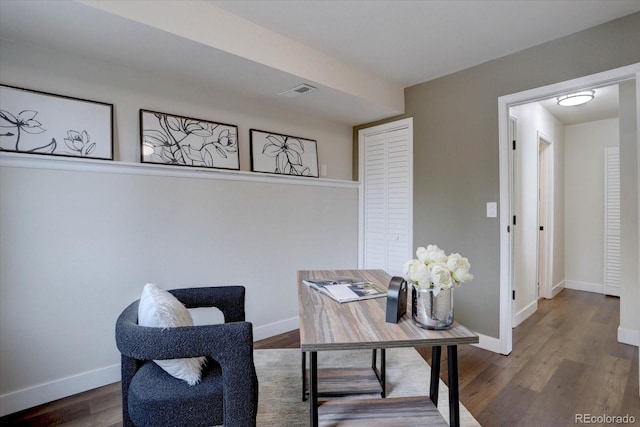 interior space with wood finished floors, visible vents, and baseboards
