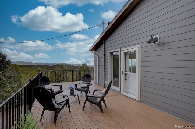 wooden terrace featuring a mountain view