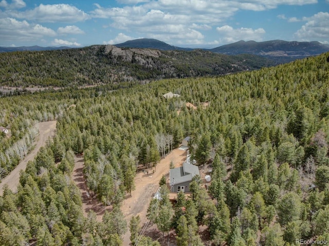 birds eye view of property featuring a forest view and a mountain view