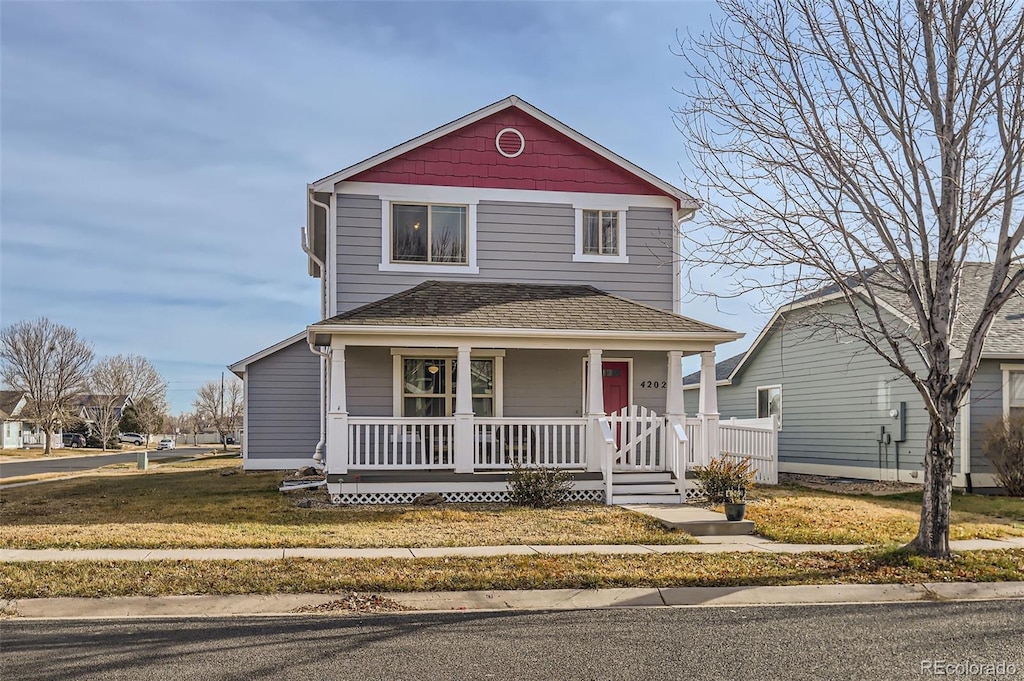 front of property featuring covered porch and a front yard