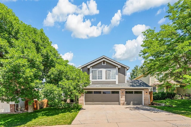 6713 W 98th Cir, Westminster, CO 80021 - view of front facade with brick siding, driveway, a front yard, a shingled roof, and an attached garage