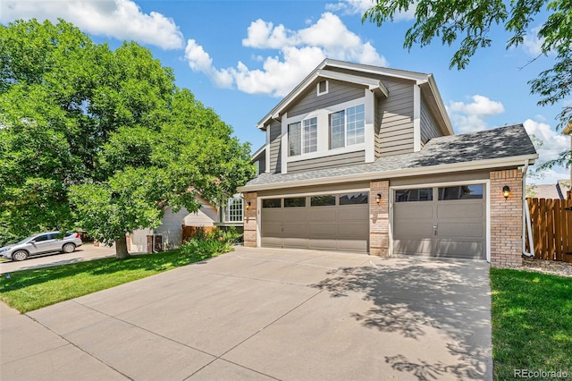 6713 W 98th Cir, Westminster, CO 80021 - view of front of home featuring brick siding, driveway, an attached garage, and a shingled roof