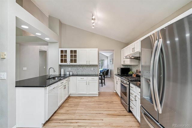 6713 W 98th Cir, Westminster, CO 80021 - kitchen with stainless steel appliances, light wood-type flooring, glass insert cabinets, under cabinet range hood, and white cabinetry