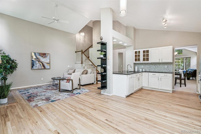 6713 W 98th Cir, Westminster, CO 80021 - living area with stairway, light wood-style flooring, a ceiling fan, and high vaulted ceiling