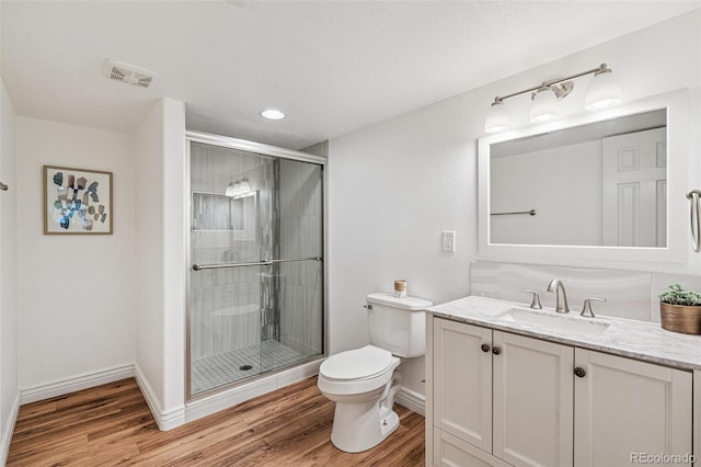 6713 W 98th Cir, Westminster, CO 80021 - bathroom featuring vanity, wood finished floors, a stall shower, and recessed lighting