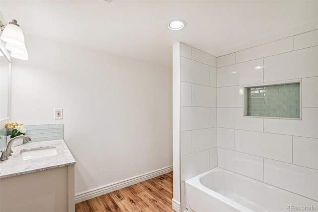 6713 W 98th Cir, Westminster, CO 80021 - bathroom featuring vanity, wood finished floors, and  shower combination