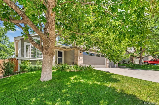 6713 W 98th Cir, Westminster, CO 80021 - obstructed view of property featuring driveway, an attached garage, and brick siding
