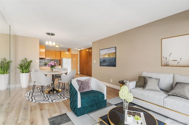 living room with light wood-style flooring and baseboards