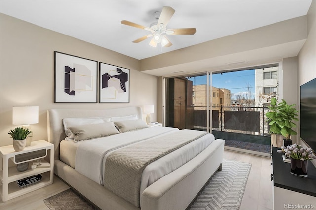 bedroom featuring access to outside, a ceiling fan, and wood finished floors