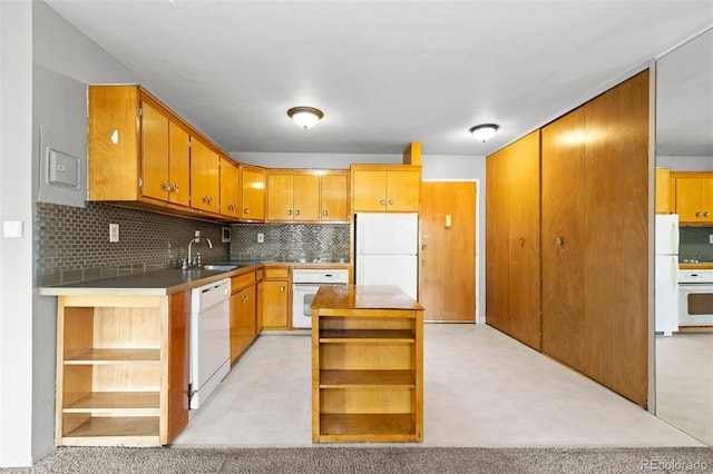 kitchen with white appliances, a sink, open shelves, tasteful backsplash, and brown cabinetry