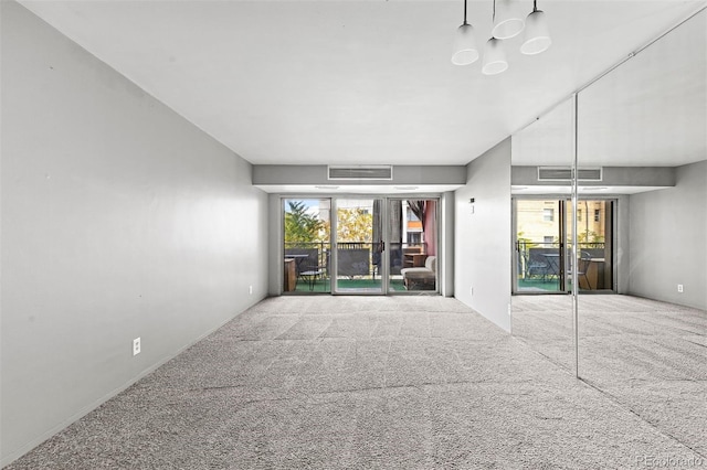 spare room with a healthy amount of sunlight, visible vents, and carpet flooring