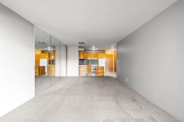 unfurnished living room featuring carpet flooring