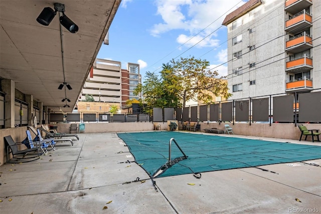 pool featuring a patio area and fence