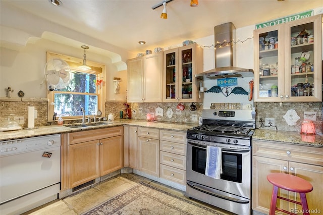232 N 14th St, Colorado Springs, CO 80904 - kitchen featuring white dishwasher, stainless steel gas stove, wall chimney range hood, a sink, and backsplash