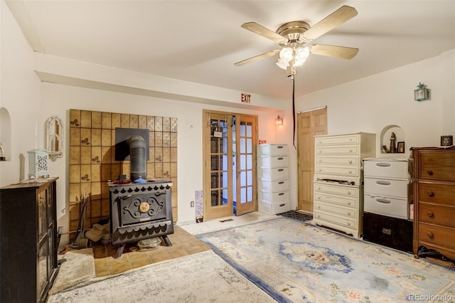232 N 14th St, Colorado Springs, CO 80904 - bedroom with a wood stove, french doors, light tile patterned floors, ceiling fan, and arched walkways