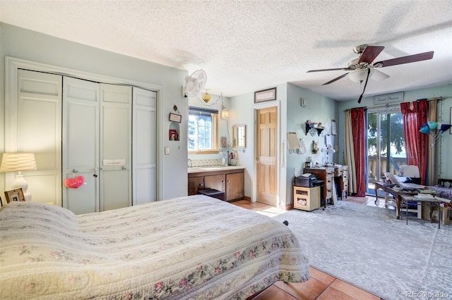 232 N 14th St, Colorado Springs, CO 80904 - bedroom featuring access to outside, light carpet, light tile patterned floors, a closet, and connected bathroom