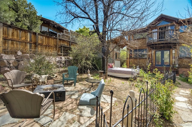 232 N 14th St, Colorado Springs, CO 80904 - view of patio / terrace featuring a fire pit, a balcony, fence, and french doors