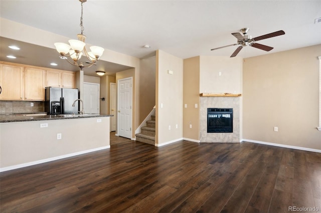 kitchen with heating unit, dark wood-style flooring, light brown cabinetry, stainless steel fridge, and open floor plan