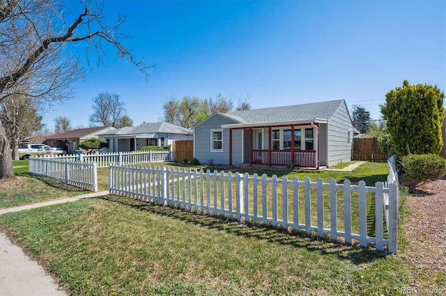 view of front of house with a fenced front yard and a front lawn