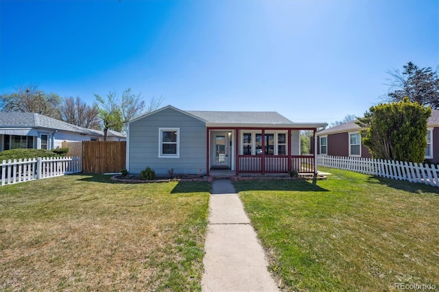 view of front of property featuring a porch, a fenced backyard, and a front yard