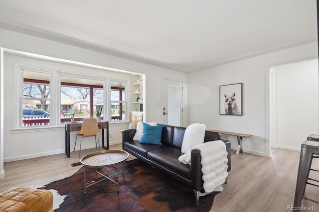 living area with light wood-style floors and baseboards