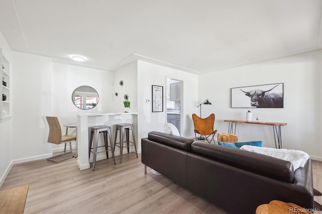 living room with baseboards and light wood-style flooring