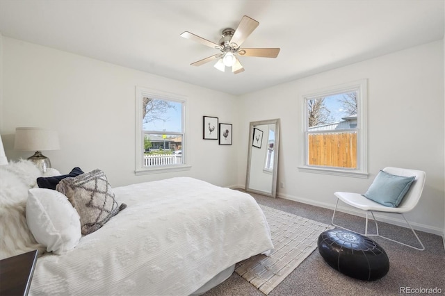 carpeted bedroom featuring baseboards and ceiling fan