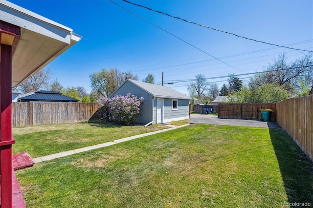 view of yard featuring a fenced backyard and an outdoor structure