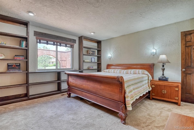 carpeted bedroom with a textured ceiling