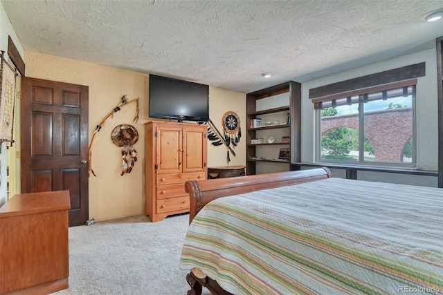 carpeted bedroom featuring a textured ceiling