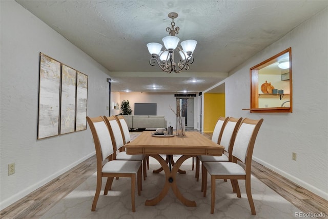 dining space featuring an inviting chandelier and hardwood / wood-style flooring