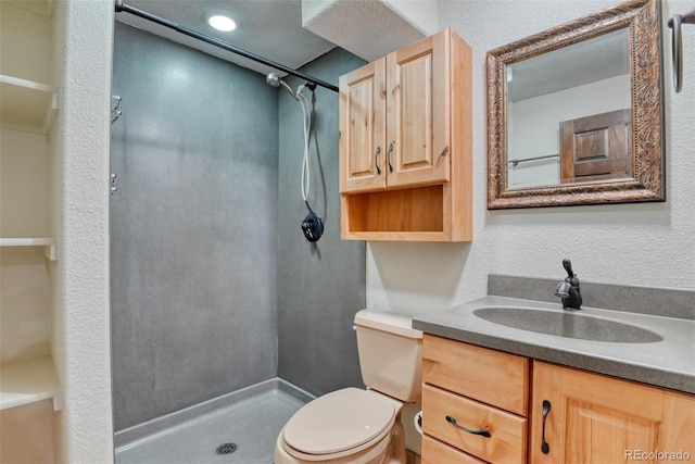 bathroom featuring walk in shower, vanity, and toilet