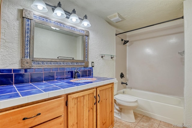 full bathroom featuring tasteful backsplash, tub / shower combination, tile patterned floors, a textured ceiling, and vanity